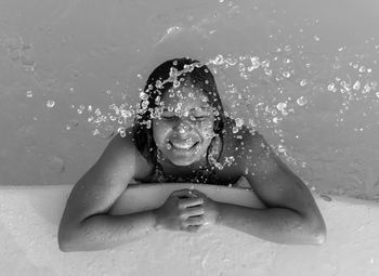 Happy woman swimming in pool