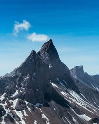 Scenic view of snowcapped mountains against blue sky