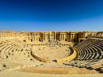 Scenic view of roman theatre against clear blue sky