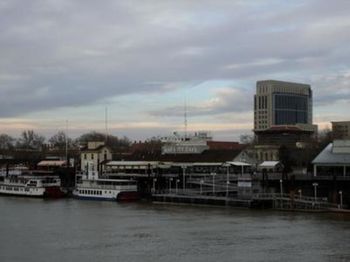 Boats in river with buildings in background