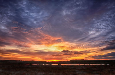 Scenic view of dramatic sky over sea during sunset