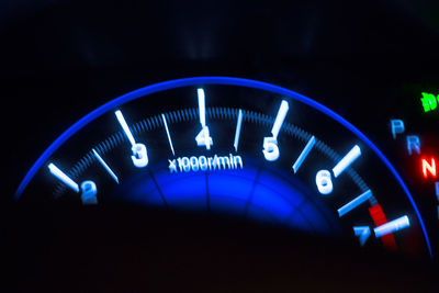 Close-up of illuminated blue car at night
