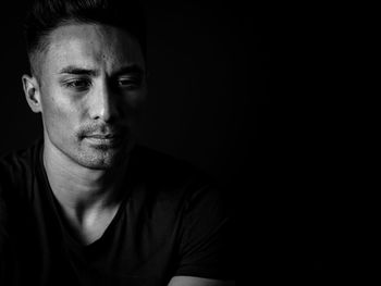 Portrait of mid adult man against black background