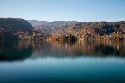 Scenic view of lake and mountains against clear sky