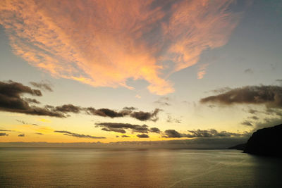 Scenic view of sea against romantic sky at sunset