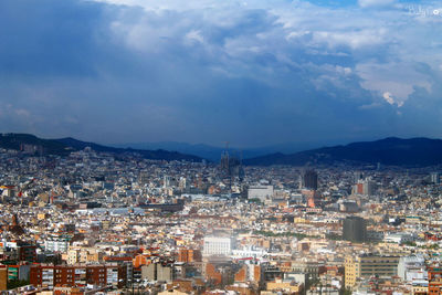 High angle view of city against cloudy sky