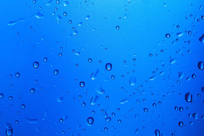 Full frame shot of raindrops on blue sky