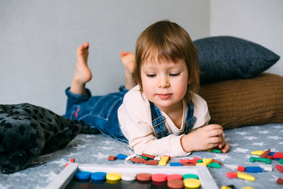Girl playing with puzzle at home