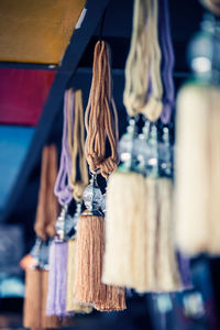 Close-up of clothes hanging on ceiling at market stall