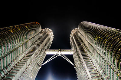 Low angle view of illuminated buildings against sky at night