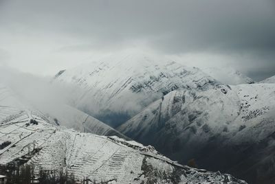 Scenic view of snow covered mountains against sky