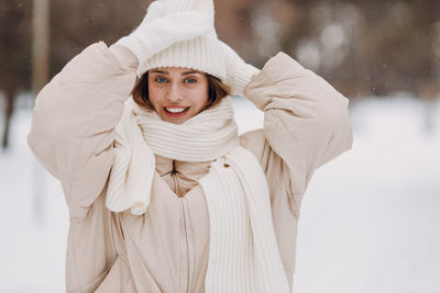 Portrait of young woman wearing warm clothing standing outdoors