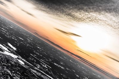Aerial view of sea against sky at sunset