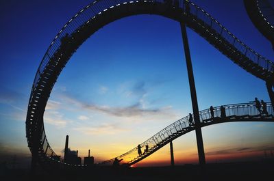 Low angle view of bridge against sky during sunset