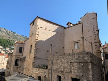 Low angle view of historic building against blue sky