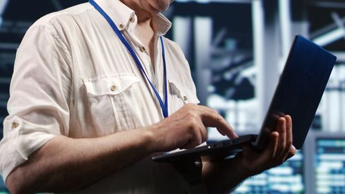 Midsection of man using digital tablet