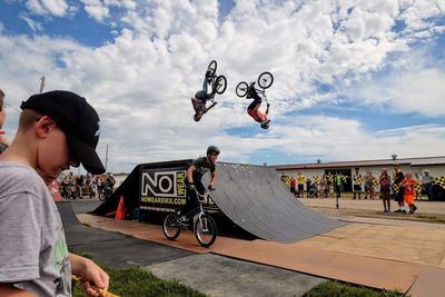 People on bicycle against sky