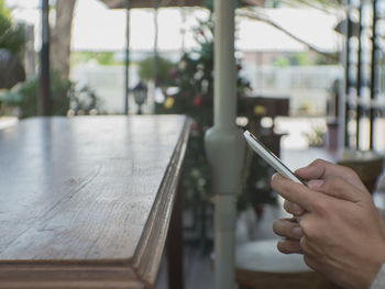 Close-up of hand holding mobile phone