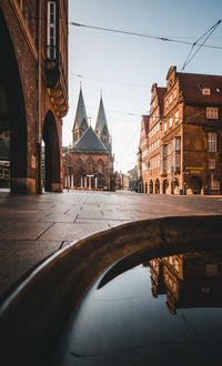 Bridge over canal amidst buildings in city