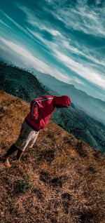 Man standing on mountain against sky