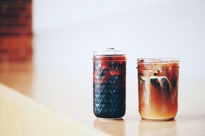 Close-up of beer in glass jar on table