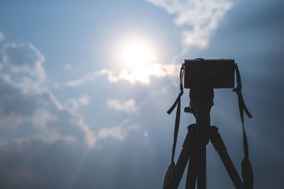 Low angle view of camera against sky during sunset