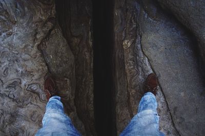 Low section of man standing on tiled floor