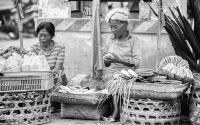 Portrait of people sitting at market stall