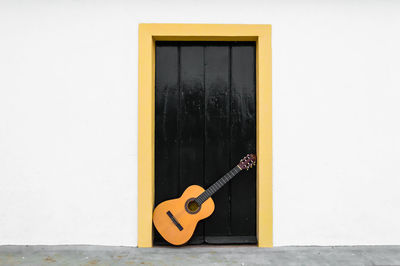 Electric guitar on yellow wall