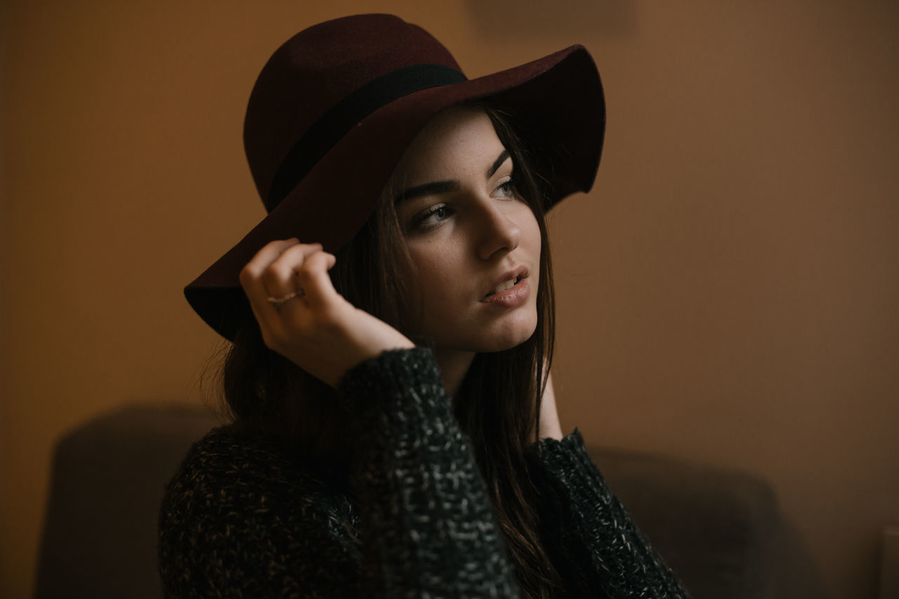 young adult, young women, hat, real people, beautiful woman, one person, fashion, lifestyles, studio shot, leisure activity, focus on foreground, front view, headshot, beauty, women, standing, fashion model, portrait, close-up, warm clothing, outdoors, day