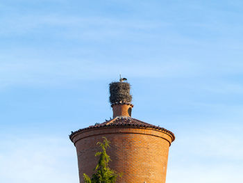 Low angle view of bell tower against sky