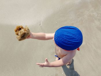 High angle view of boy playing with sponge