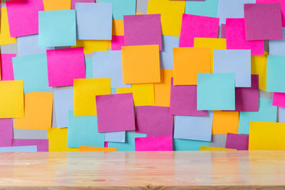 Close-up of multi colored adhesive notes on bulletin board in office