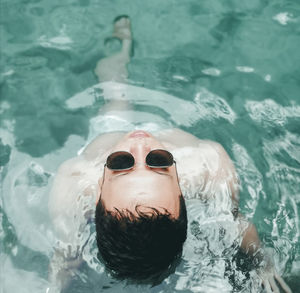 High angle view of woman swimming in pool