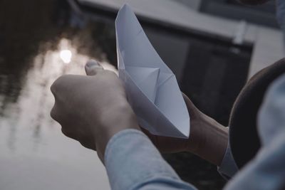 Close-up of woman holding paper boat