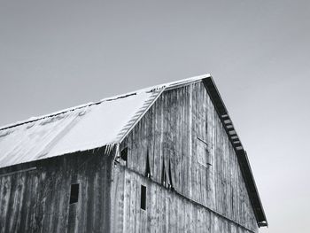 Low angle view of wooden house against clear sky