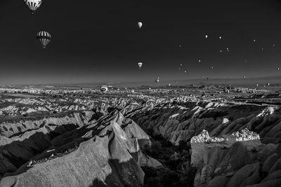 Hot air balloons over rocky mountains at cappadocia