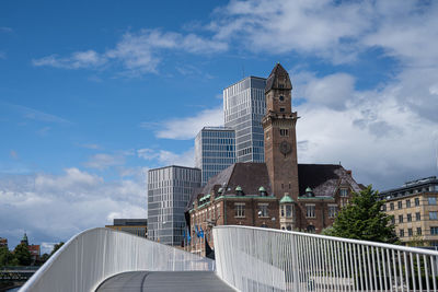 Low angle view of modern building against cloudy sky