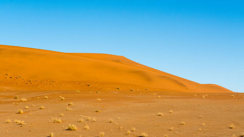 Scenic view of desert against clear sky