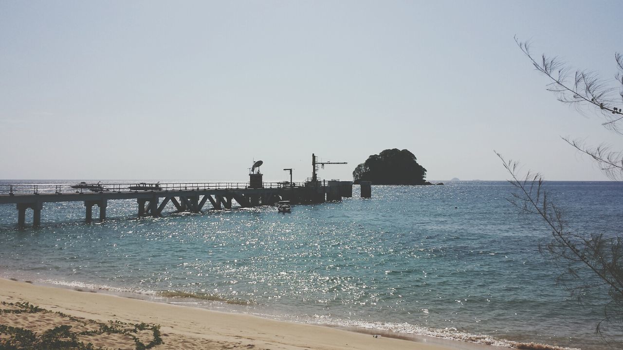 water, sea, beach, clear sky, tranquil scene, horizon over water, tranquility, shore, scenics, copy space, sand, beauty in nature, nature, pier, incidental people, idyllic, bird, sky, outdoors, silhouette