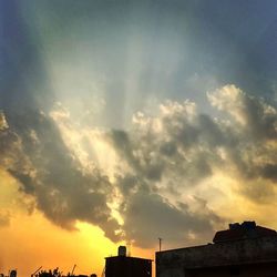 Low angle view of cloudy sky at sunset