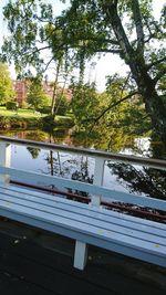 Swimming pool by trees against sky