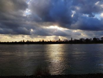 Panoramic view of city by lake against sky