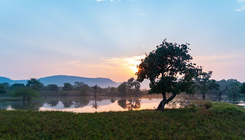 Scenic view of lake against sky during sunset