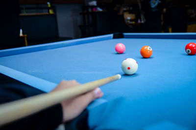 Cropped hand playing pool
