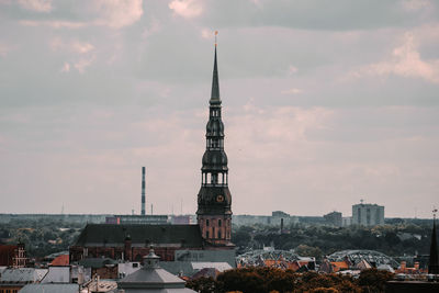  st peters church tower in riga, city against cloudy sky