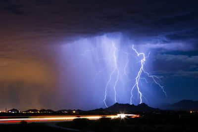 Lightning in sky over city at night