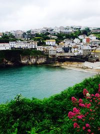 View of townscape by sea against sky