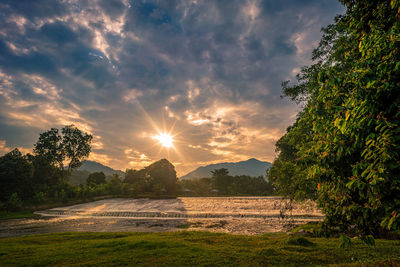 Scenic view of field against sky during sunset