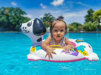 Portrait of cute girl in swimming pool